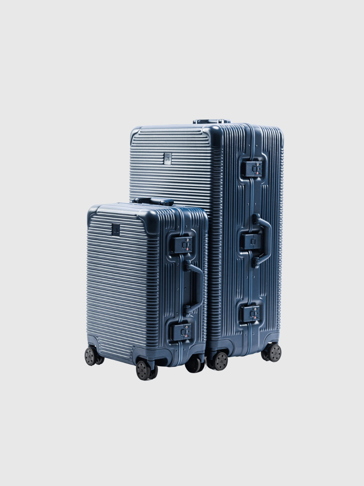 Navy travel luggage set featuring a durable polycarbonate shell and aluminum framing, stacked for compact storage.