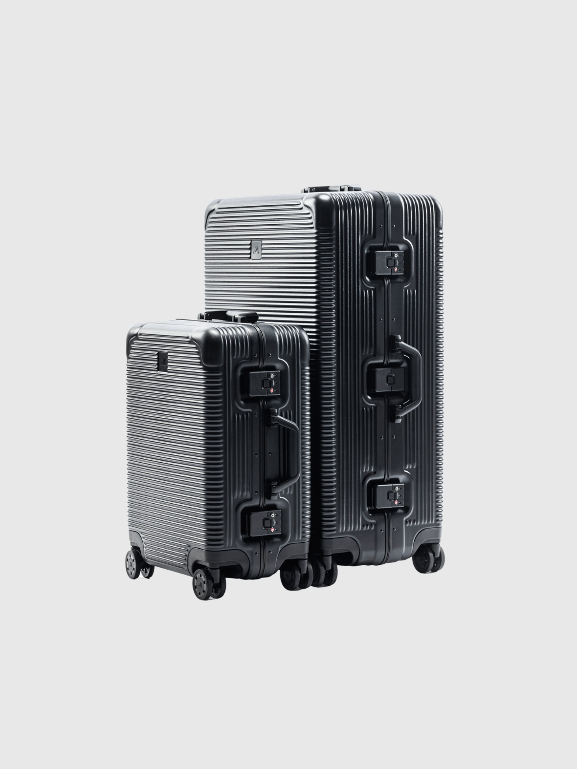 The Signature Series 'Advanced' black luggage set, featuring durable polycarbonate and aluminum design, perfect for travel.